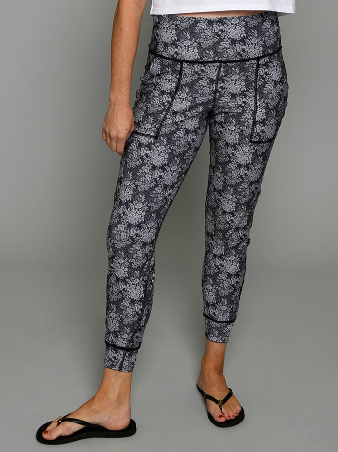 Flip Outfit Reversible Women’s Joggers, Pants - tonal grey constellation floral print reverses to grey plaid. Mid-rise sweat-wicking UPF 50. Made in the USA from recycled plastic bottles. Made by women for women. Front view of grey floral side.
